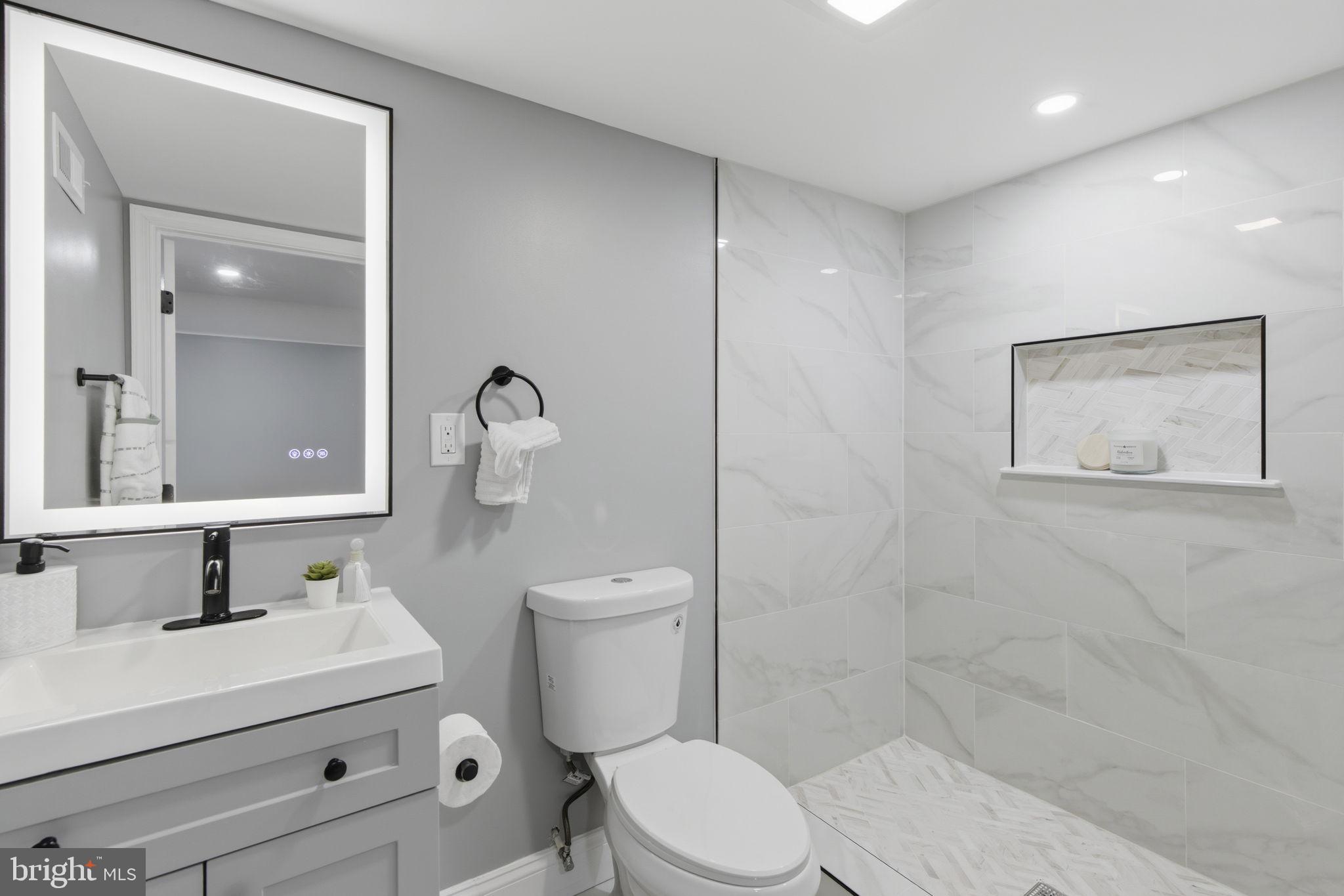 1600 Federal Street Baltimore, MD 21213 - Photo 13 of 31 a bathroom with a toilet sink vanity and mirror