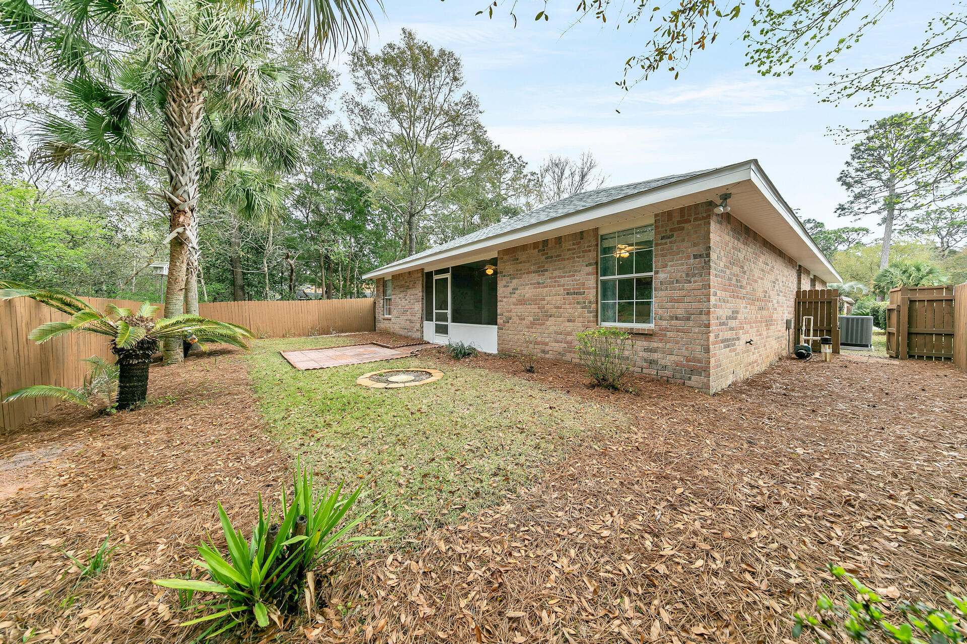 224 Bayou Landing Road Santa Rosa Beach, FL 32459 - Photo 2 of 25 a backyard of a house with table and chairs