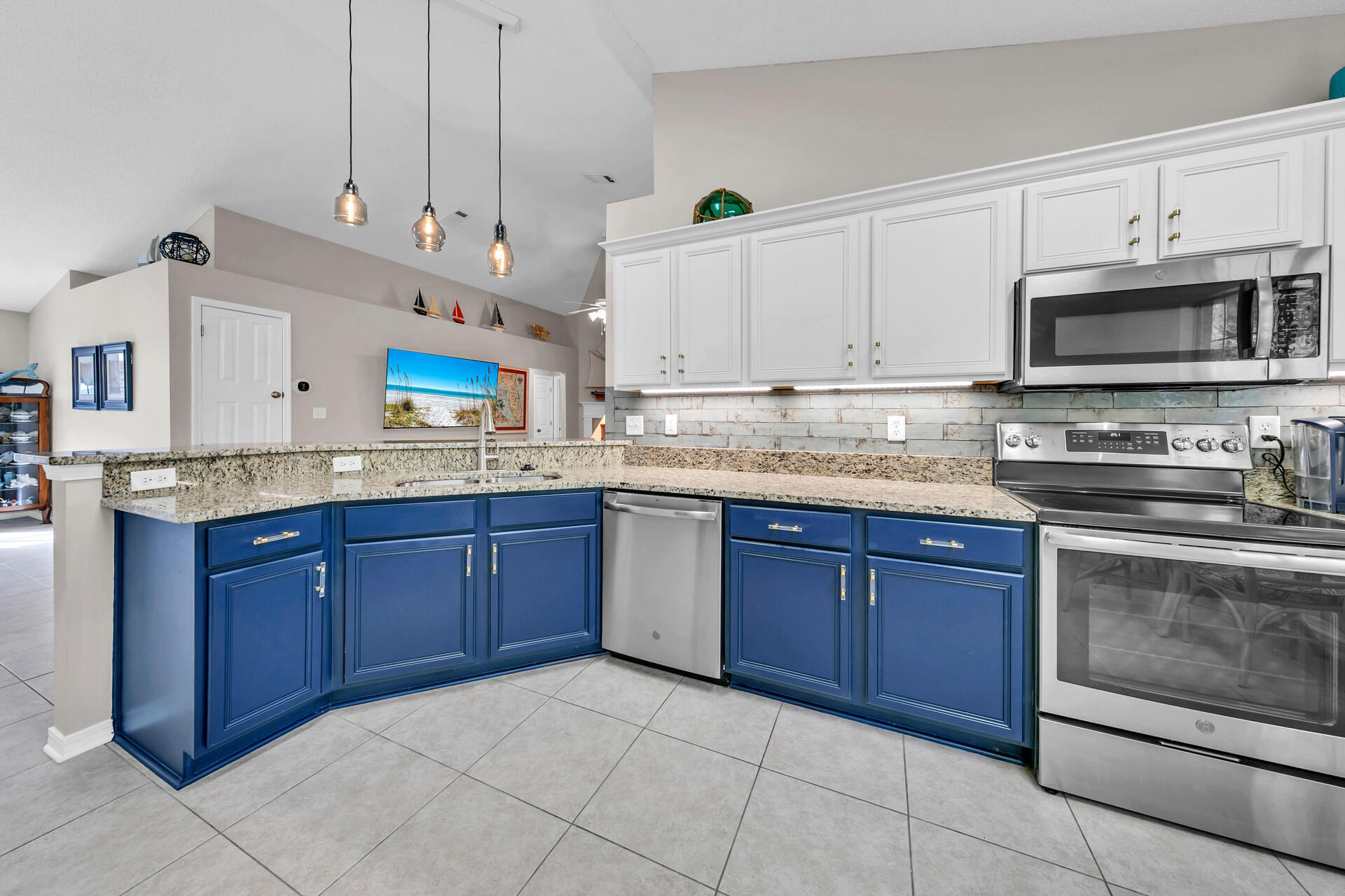 224 Bayou Landing Road Santa Rosa Beach, FL 32459 - Photo 5 of 25 a kitchen with stainless steel appliances granite countertop a sink dishwasher stove and microwave with wooden cabinets