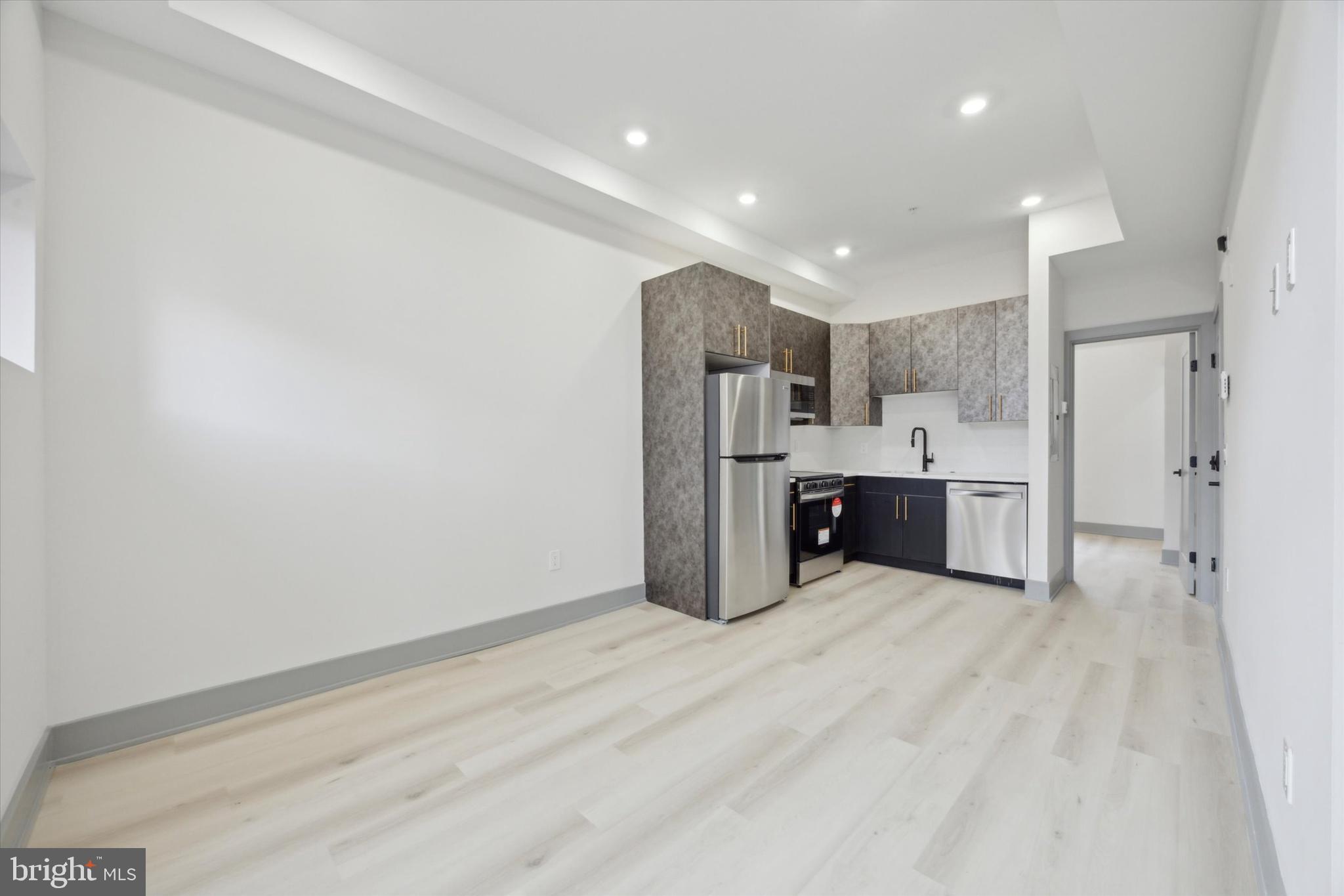 251 South 12th Street, Unit 2 Philadelphia, PA 19107 - Photo 2 of 10 a view of kitchen with refrigerator cabinets and wooden floor