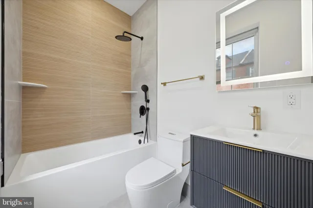 a bathroom with a sink a toilet and a bathtub