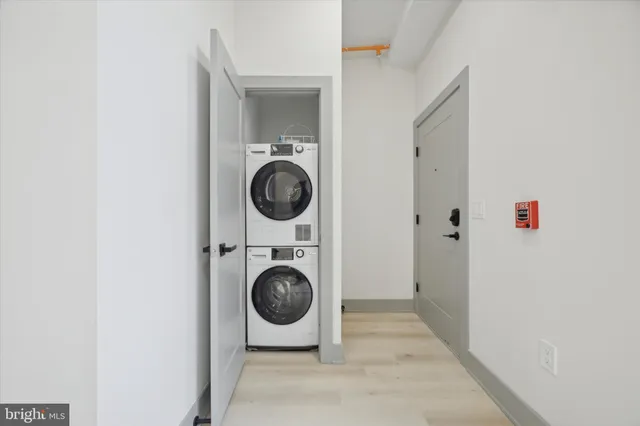 a view of a hallway with washer and dryer
