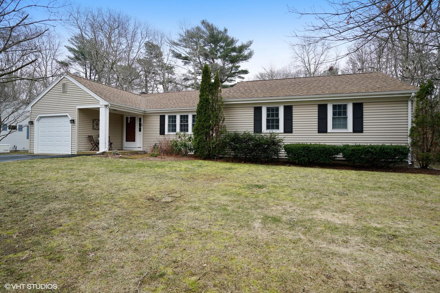 a front view of house with yard and green space