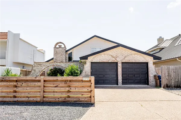 a front view of a house with garage