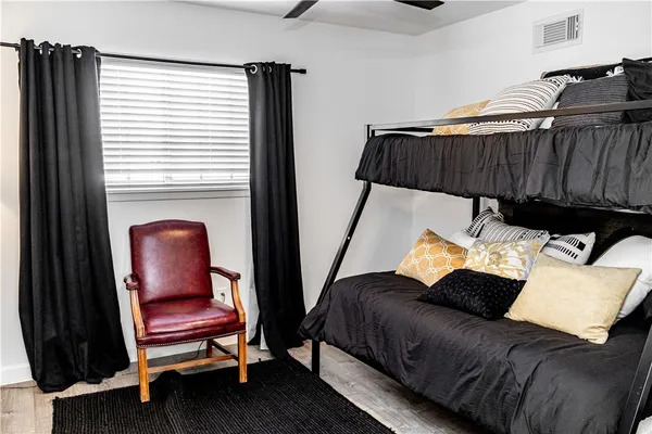 a bedroom with a bed and a chair