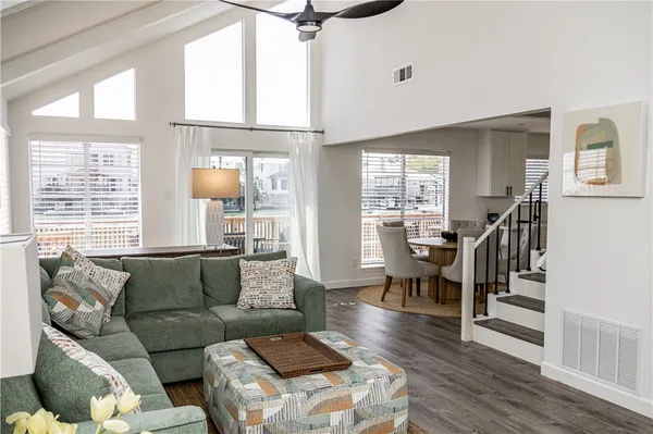 a living room with furniture wooden floor and a large window