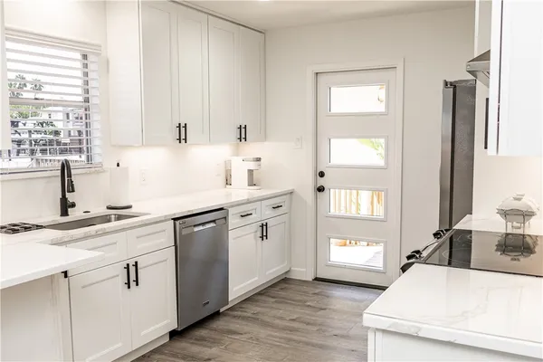 a kitchen with white cabinets and white appliances