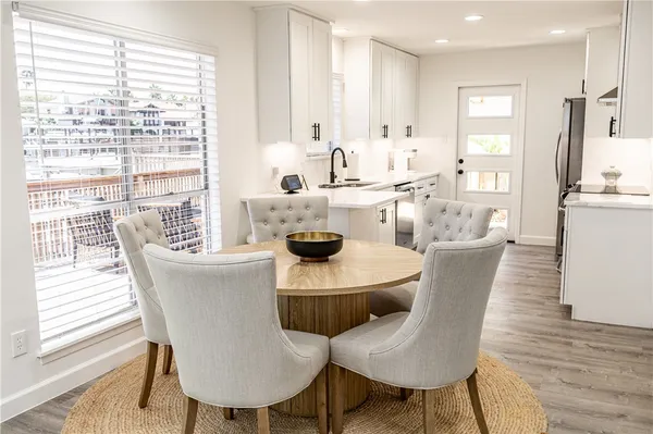 a view of a dining room with furniture and wooden floor