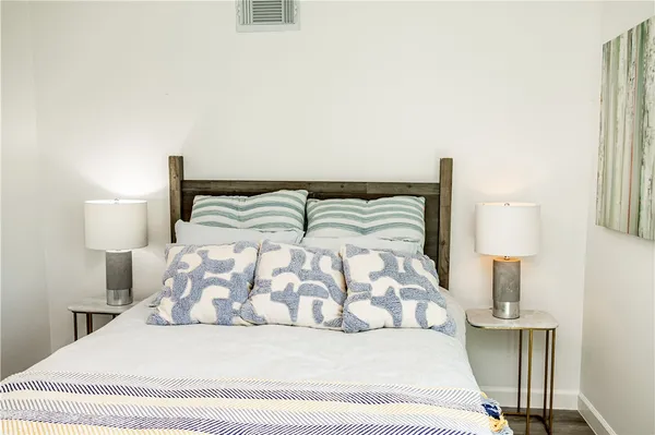 a bedroom with a bed and a night stand