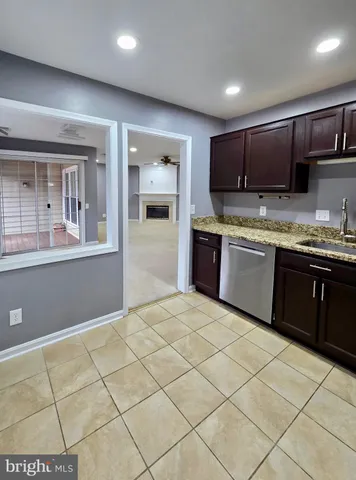 a large kitchen with stainless steel appliances granite countertop a sink and cabinets