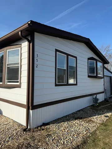 a view of a house with wooden fence