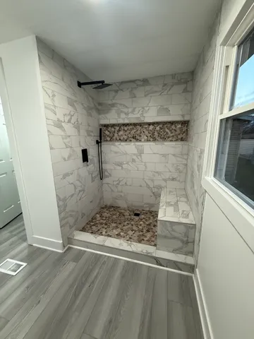 a view of a room with wooden floor