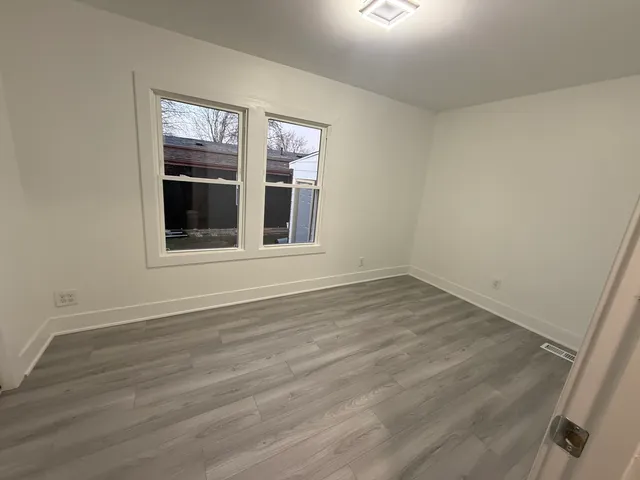 a view of an empty room and wooden floor