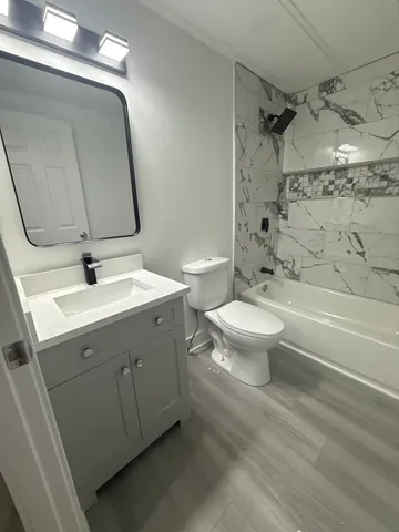 a bathroom with a sink toilet and shower