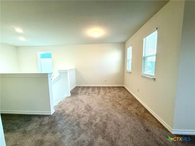 a view of a big room with carpet