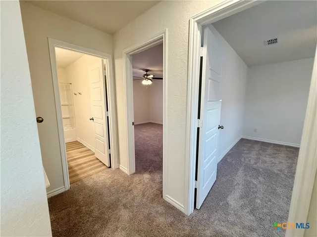 a view of a livingroom with a ceiling fan and window