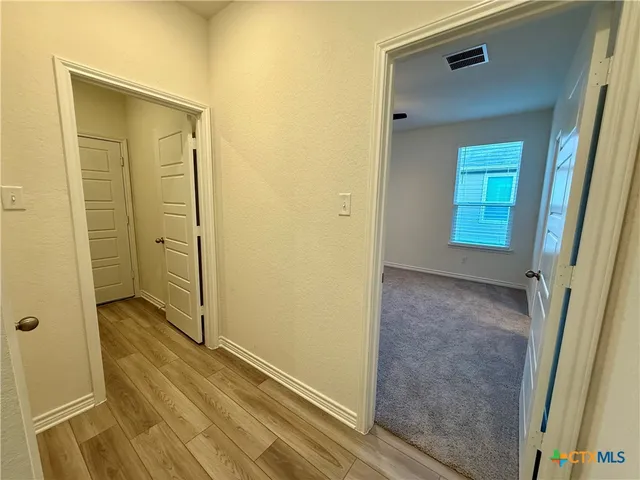 a view of a livingroom with a ceiling fan and window