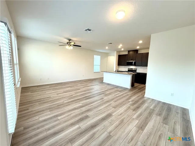 a large kitchen with stainless steel appliances kitchen island granite countertop a large counter top stainless steel appliances and cabinets