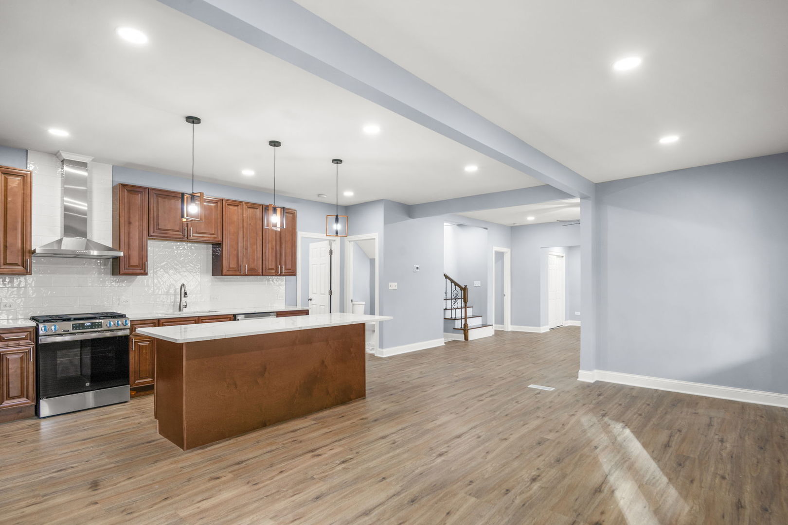 2402 North 41st Road Sheridan, IL 60551 - Photo 11 of 30 a large kitchen with stainless steel appliances kitchen island a large counter top and a wooden floors