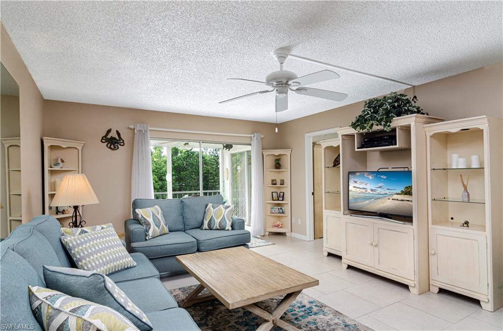 5499 Rattlesnake Hammock Road, Unit A206 Naples, FL 34113 - Photo 1 of 23 a living room with furniture and a window