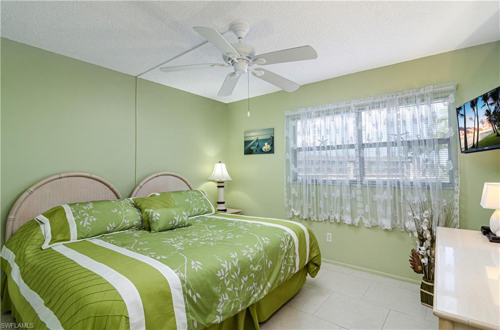 5499 Rattlesnake Hammock Road, Unit A206 Naples, FL 34113 - Photo 11 of 23 a bedroom with a bed and a window