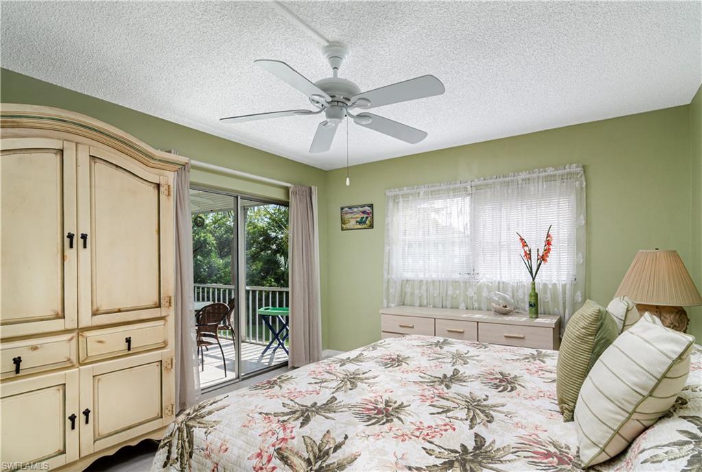 5499 Rattlesnake Hammock Road, Unit A206 Naples, FL 34113 - Photo 14 of 23 a bedroom with a large bed and a window