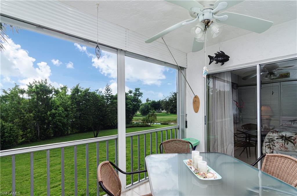 5499 Rattlesnake Hammock Road, Unit A206 Naples, FL 34113 - Photo 18 of 23 a view of a porch with furniture and yard