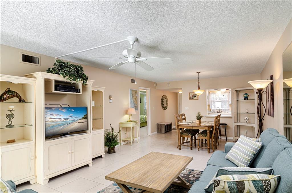 5499 Rattlesnake Hammock Road, Unit A206 Naples, FL 34113 - Photo 3 of 23 a living room with furniture and view of kitchen