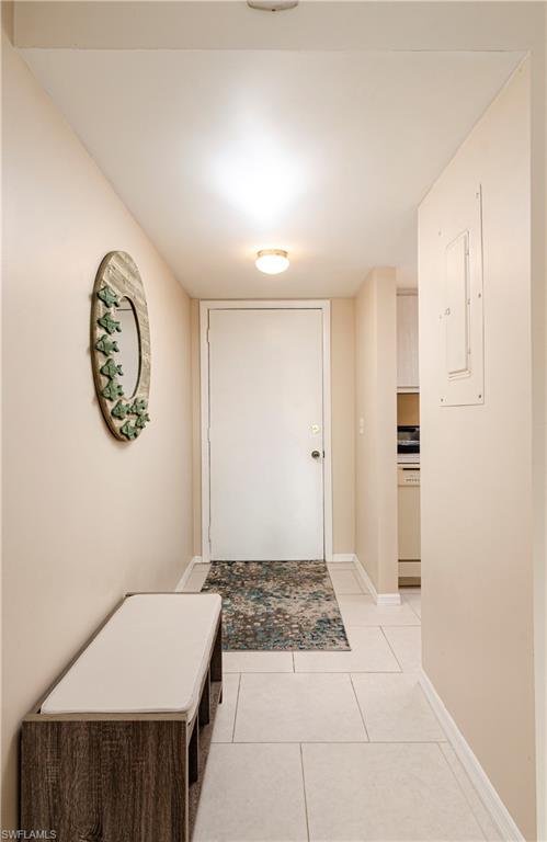 5499 Rattlesnake Hammock Road, Unit A206 Naples, FL 34113 - Photo 10 of 23 a view of a room with wooden floor and a chandelier