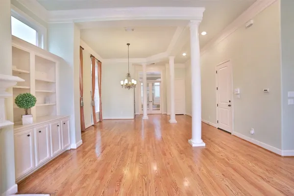 a view of a hallway with wooden floor