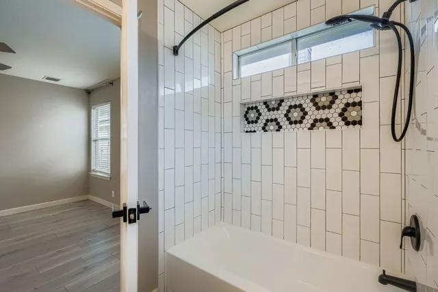 a bathroom with a bathtub and shower