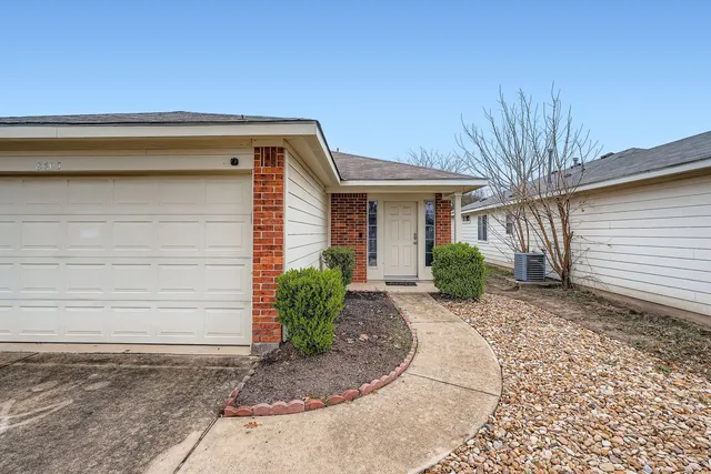 a view of a house with a backyard