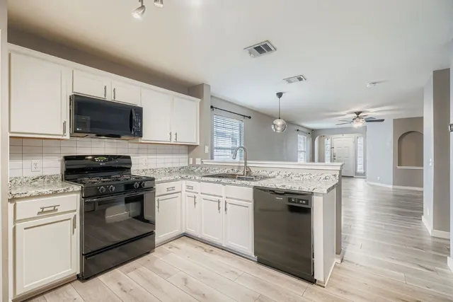 a kitchen with a stove and a sink