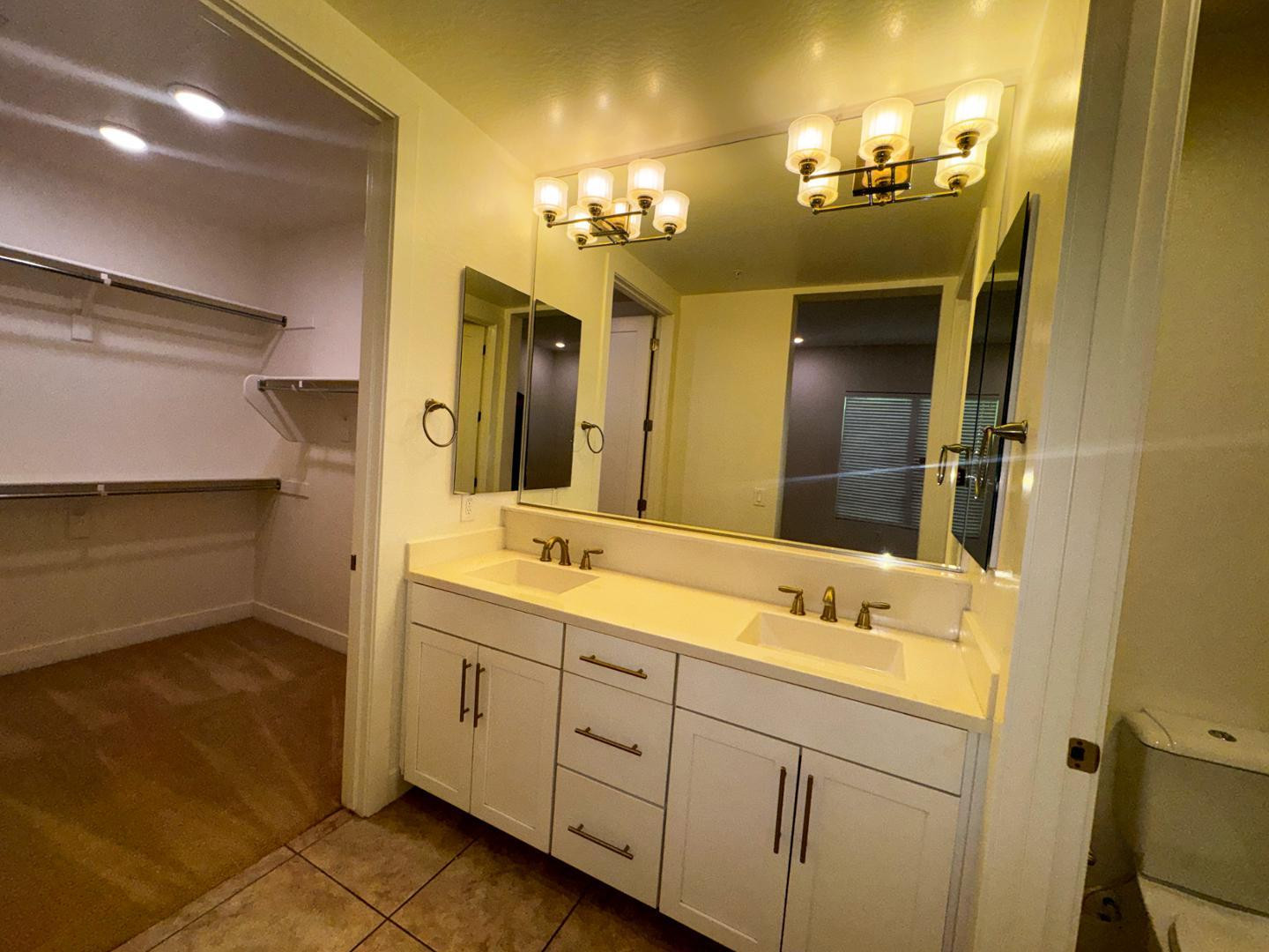 6565 East Thomas Road, Unit 1046 Scottsdale, AZ 85251 - Photo 12 of 16 a bathroom with a double vanity sink and a mirror