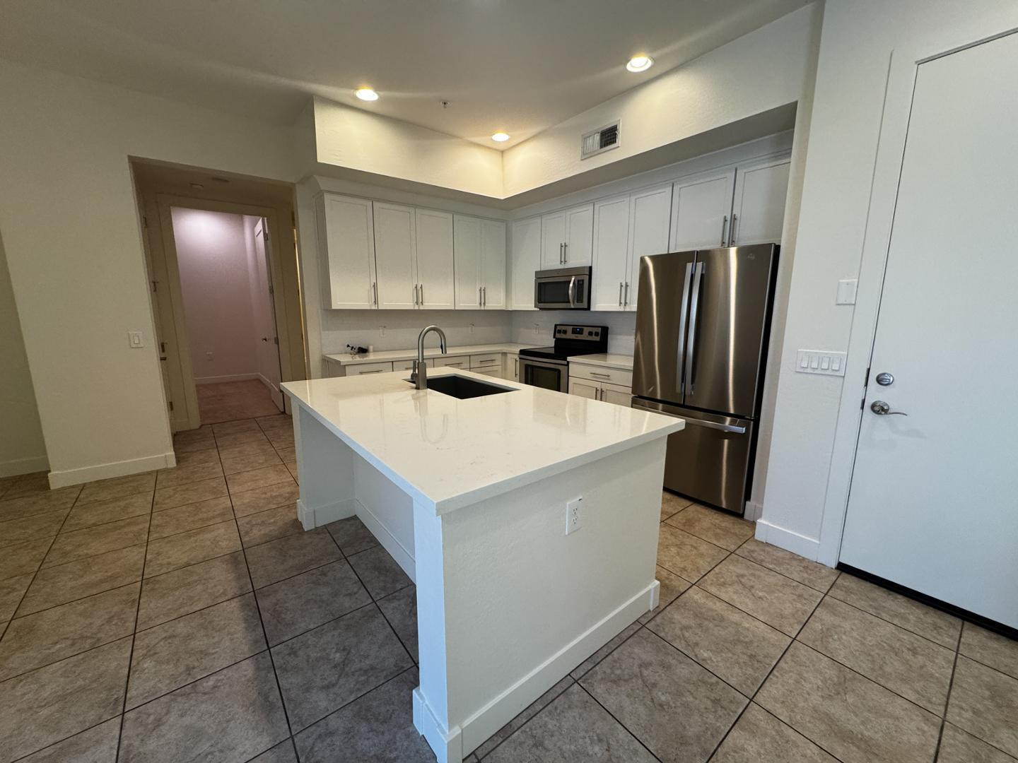 6565 East Thomas Road, Unit 1046 Scottsdale, AZ 85251 - Photo 5 of 16 a kitchen that has a sink a refrigerator and a cabinets