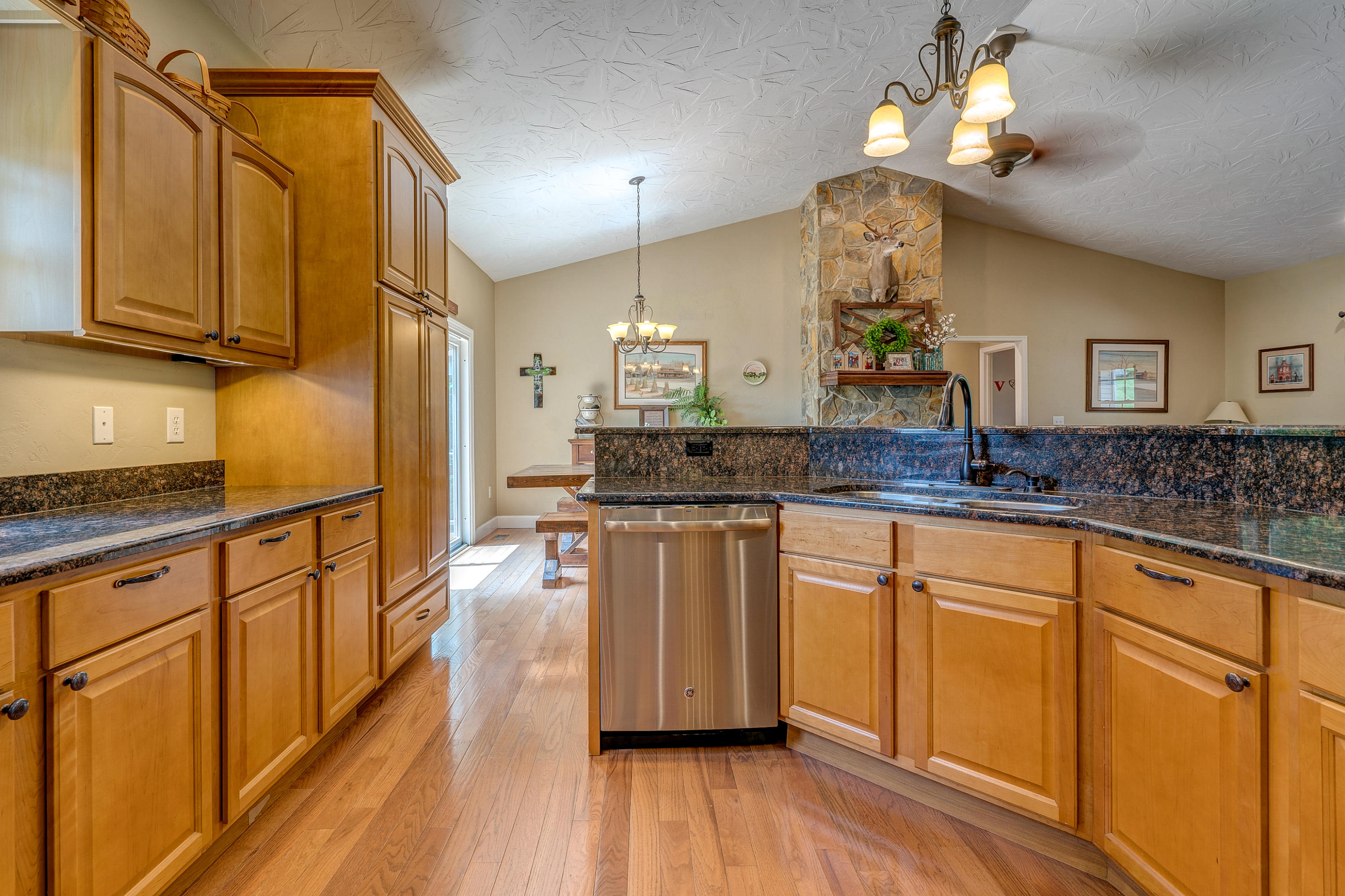 1205 Summit View Road Goodview, VA 24095 - Photo 17 of 46 a kitchen with stainless steel appliances granite countertop wooden cabinets a stove a sink and dishwasher