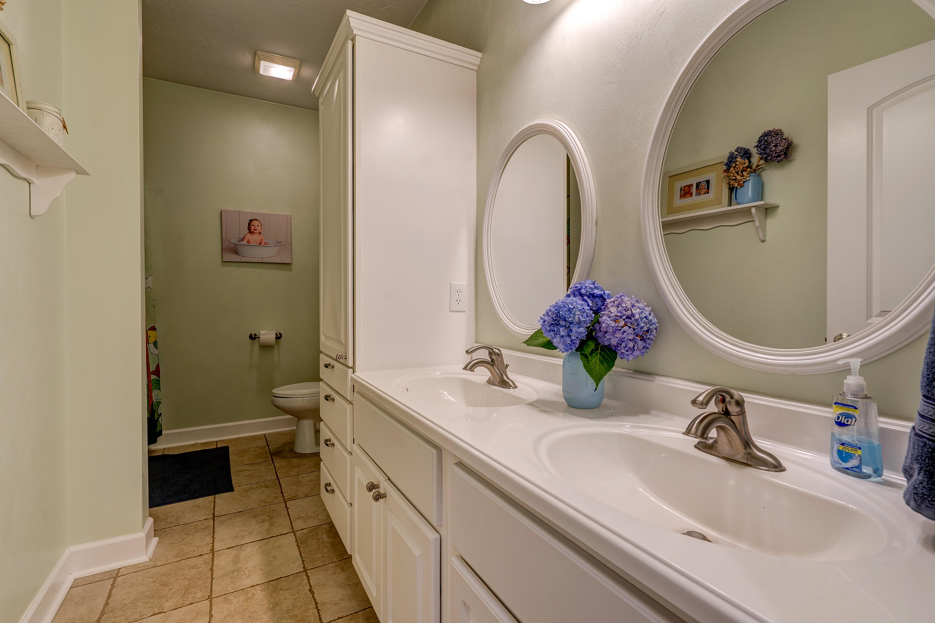 1205 Summit View Road Goodview, VA 24095 - Photo 23 of 46 a bathroom with a granite countertop sink a toilet and a mirror
