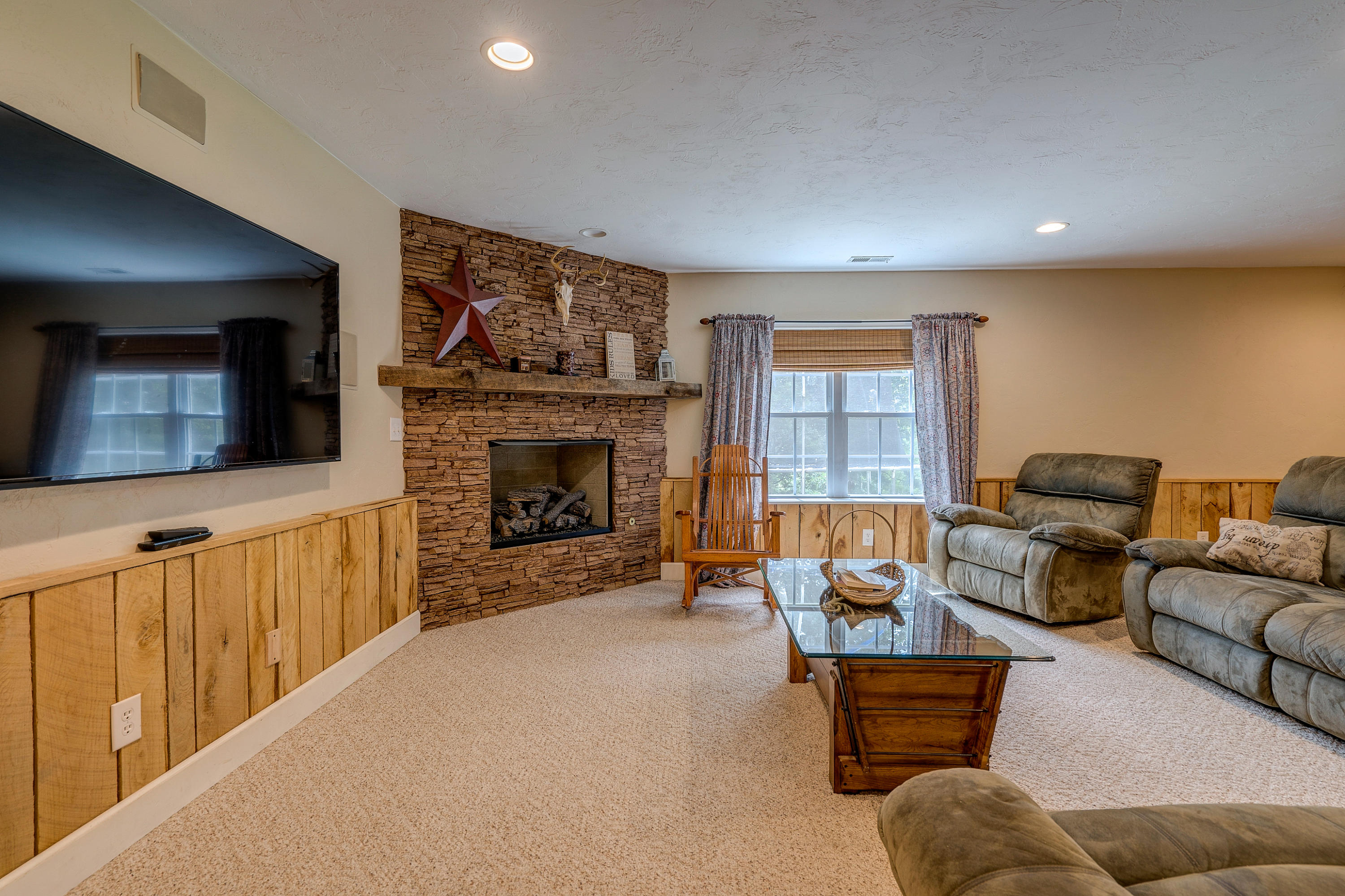 1205 Summit View Road Goodview, VA 24095 - Photo 29 of 46 a living room with furniture a flat screen tv and a fireplace