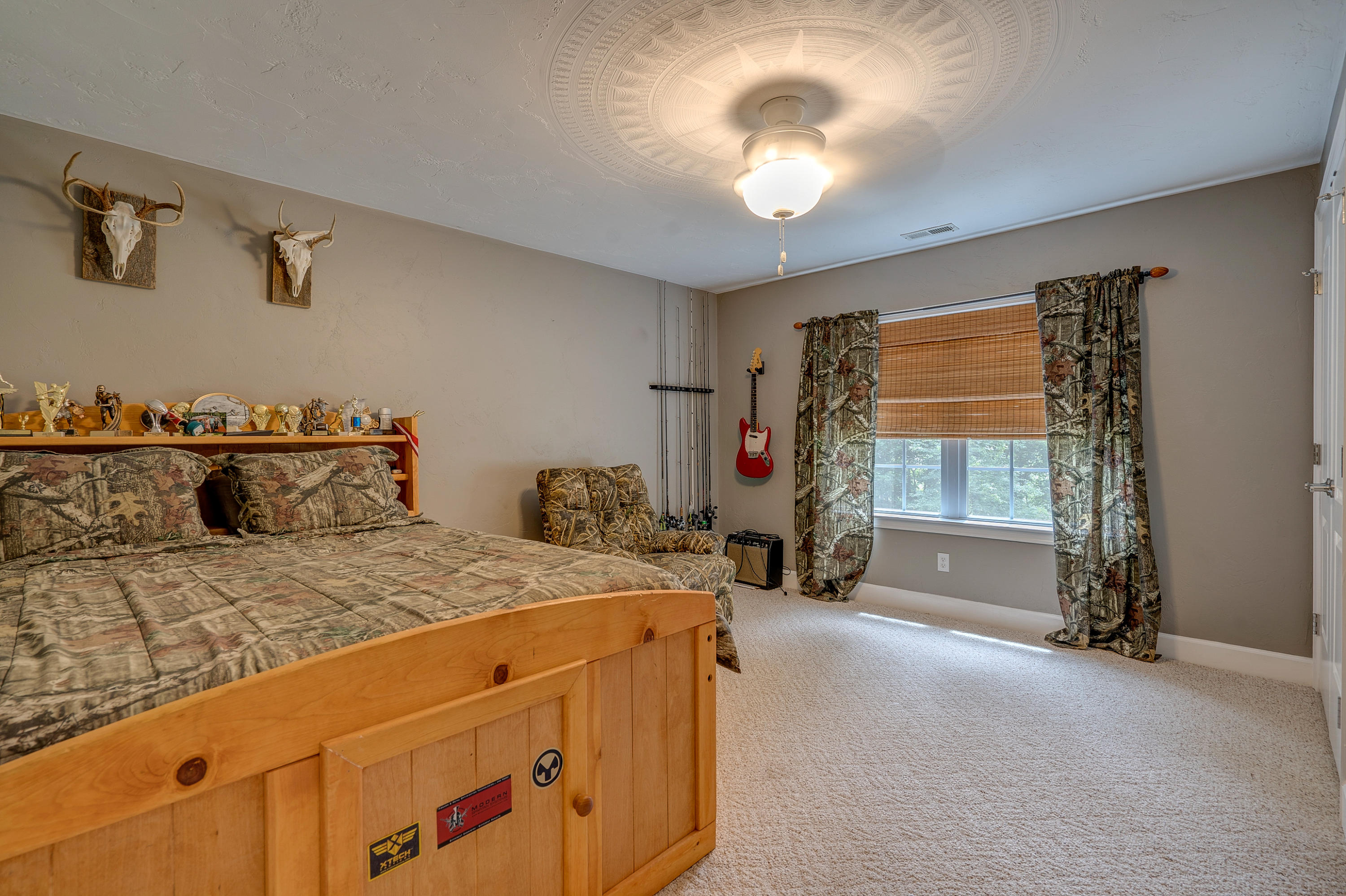 1205 Summit View Road Goodview, VA 24095 - Photo 32 of 46 a bed sitting in a room next to a window and a chandelier