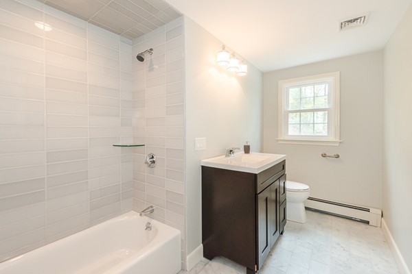 16 Mayflower Road Winchester, MA 01890 - Photo 12 of 23 a view of bathroom with bathtub window and mirror