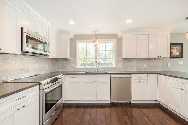 16 Mayflower Road Winchester, MA 01890 - Photo 9 of 23 a kitchen with granite countertop white cabinets white stainless steel appliances a sink and a window