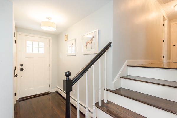 16 Mayflower Road Winchester, MA 01890 - Photo 10 of 23 a view of staircase with lots of frames on wall and a window