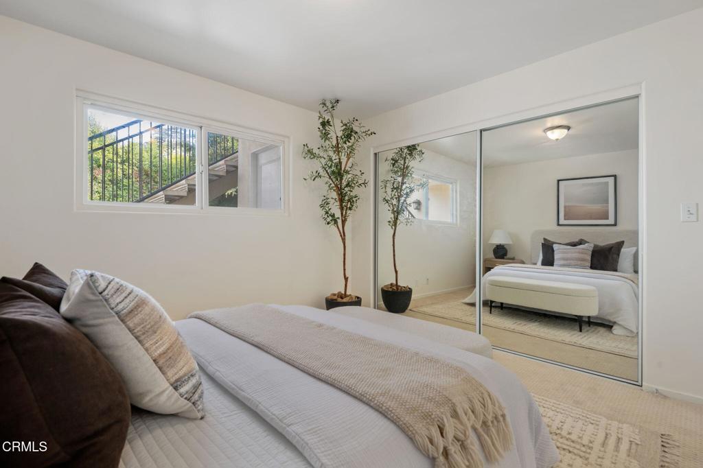 3914 Via Lucero, Unit B Santa Barbara, CA 93110 - Photo 16 of 22 a bedroom with a bed and a chandelier