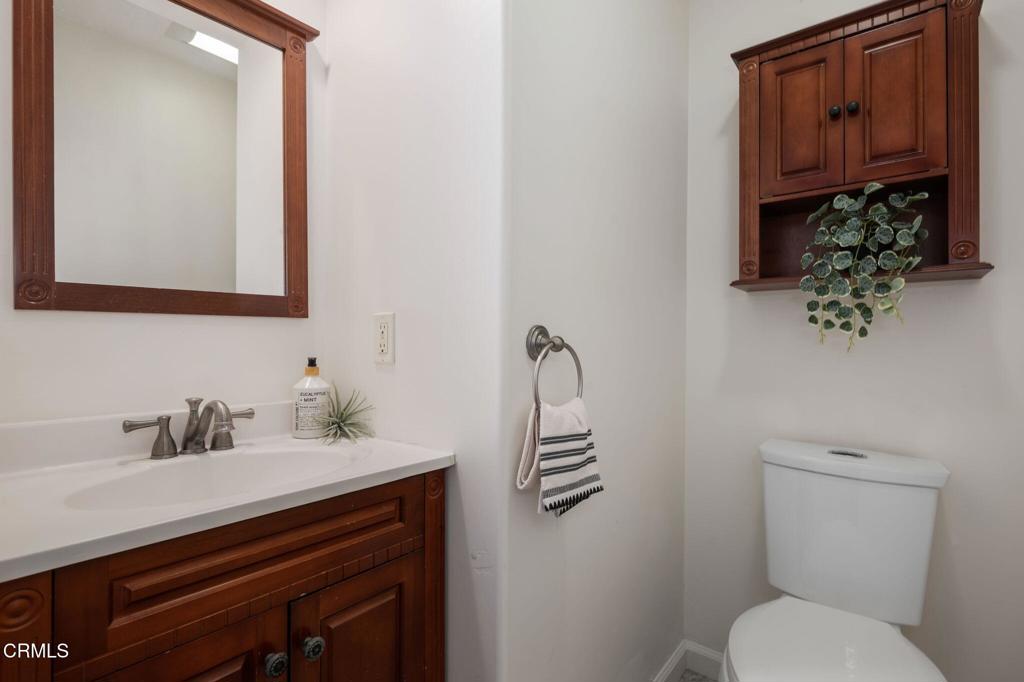 3914 Via Lucero, Unit B Santa Barbara, CA 93110 - Photo 21 of 22 a bathroom with a toilet sink and mirror