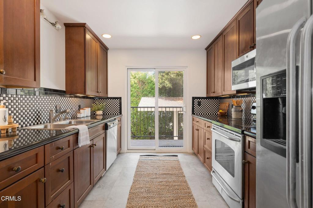 3914 Via Lucero, Unit B Santa Barbara, CA 93110 - Photo 10 of 22 a kitchen with stainless steel appliances granite countertop a stove a sink and a refrigerator