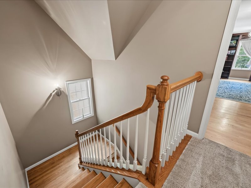 1168 Mt Pleasant Road Bangor, PA 18013 - Photo 71 of 100 Warm wood stairs guide the transition between floors beneath a bright multi-level window.