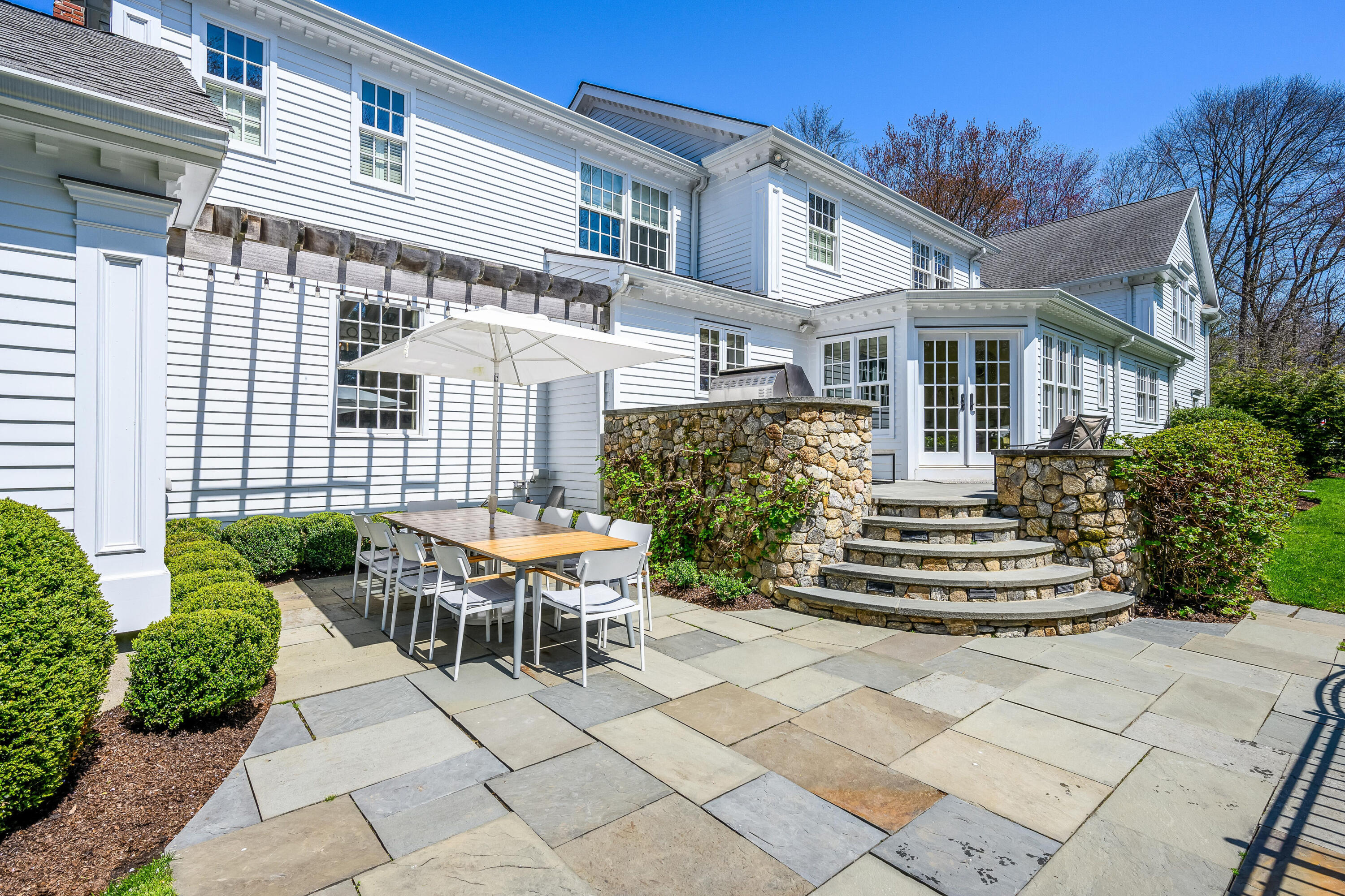 110 Stephen Mather Road Darien, CT 06820 - Photo 30 of 41 a front view of a house with a garden