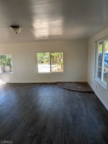 a kitchen with kitchen island granite countertop a sink a stove and white cabinets