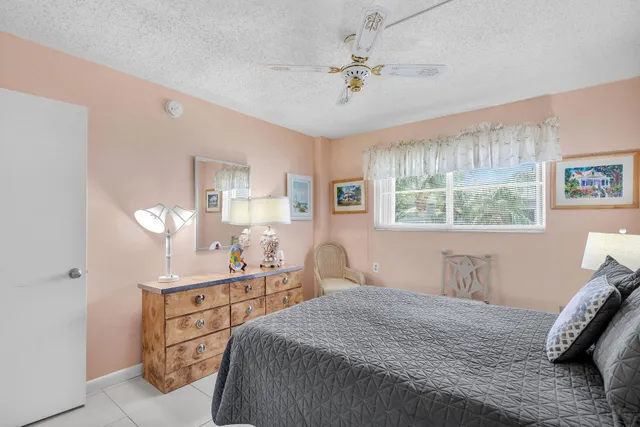 a bedroom with a bed a mirror and lamp