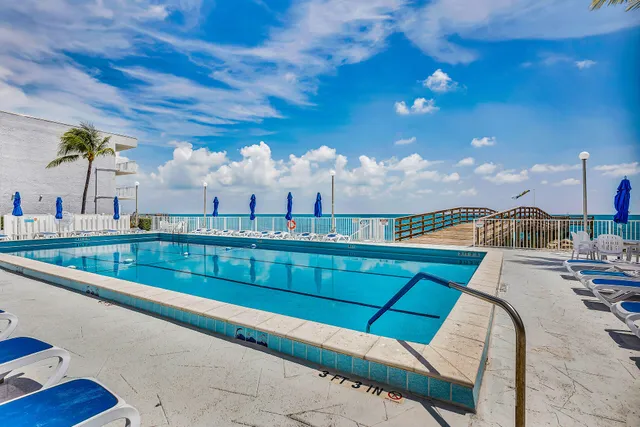 a swimming pool view with a outdoor seating space